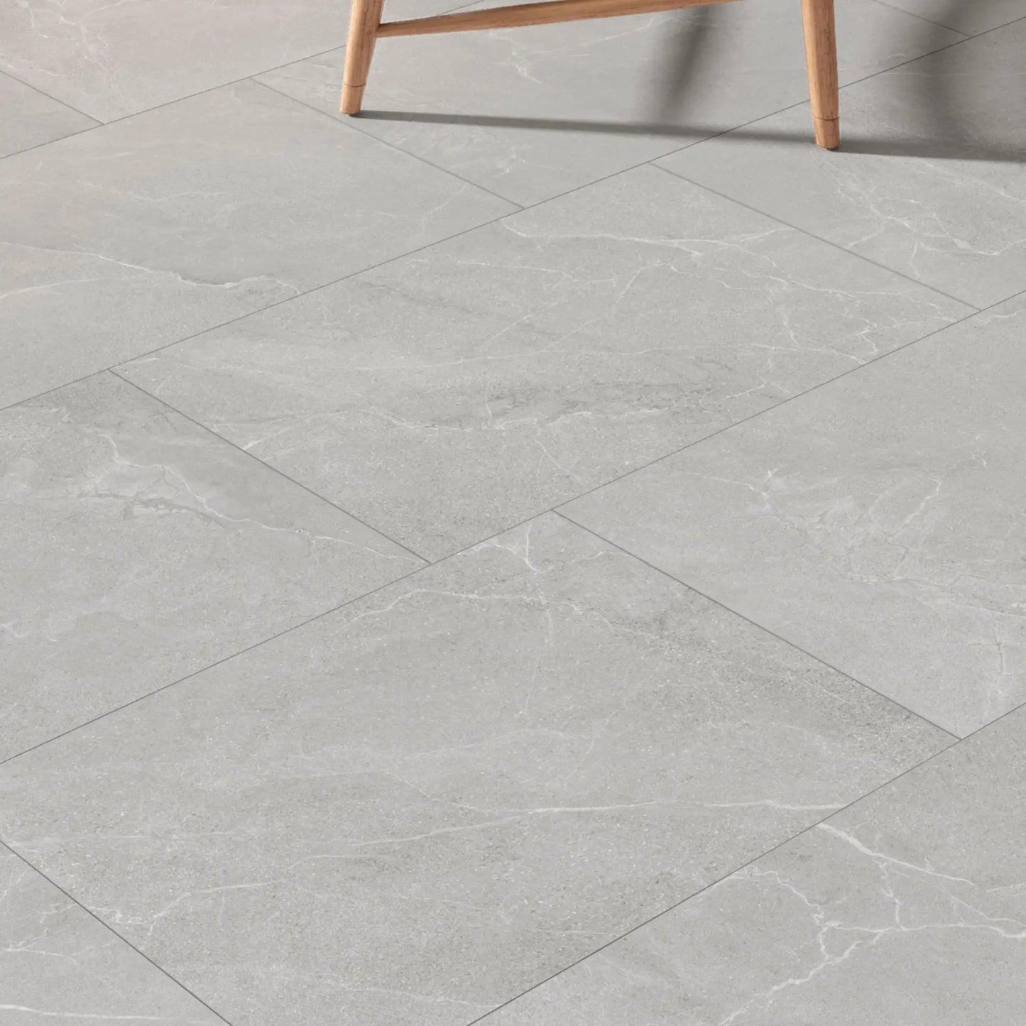 Grey stone effect porcelain tiles installed in a modern room, Cortina Stone Cenere