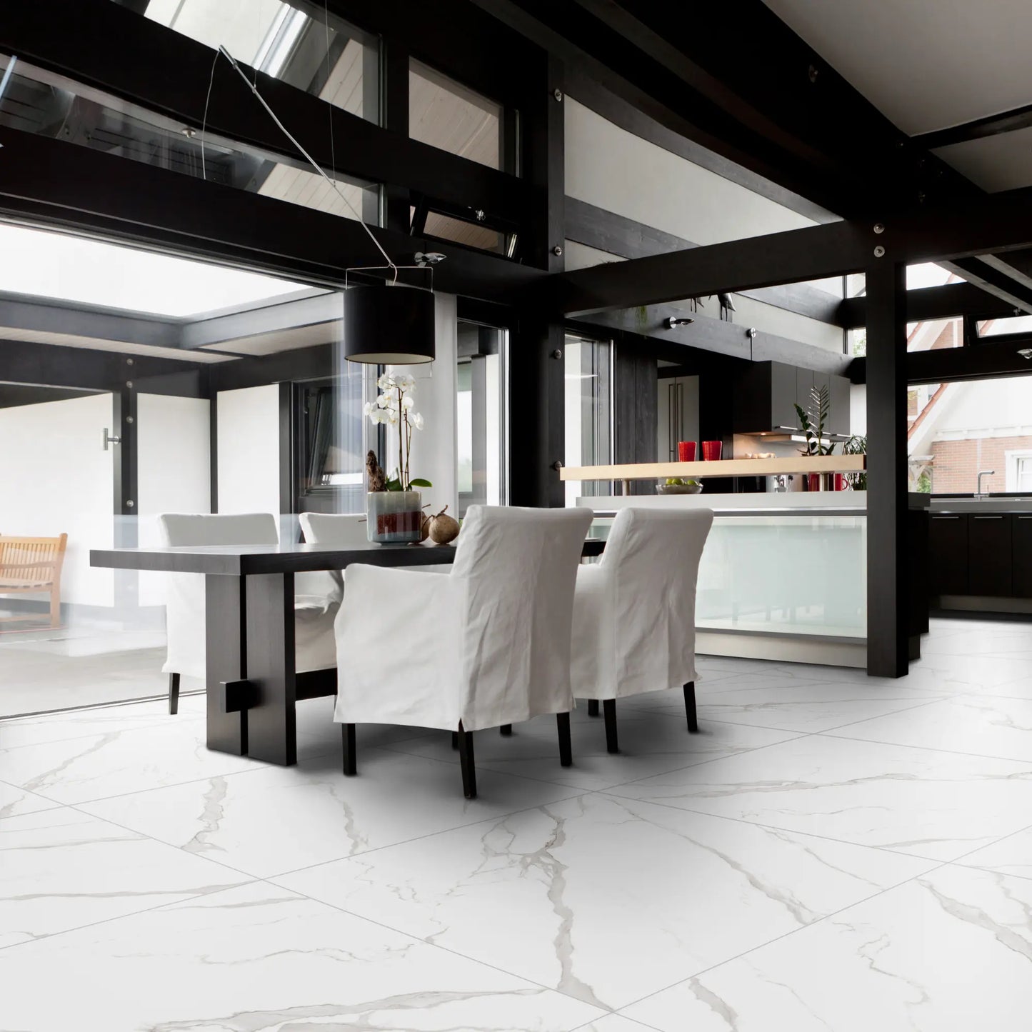 Modern dining room with matte marble-effect porcelain tile flooring, featuring soft grey veining, white marble statuario