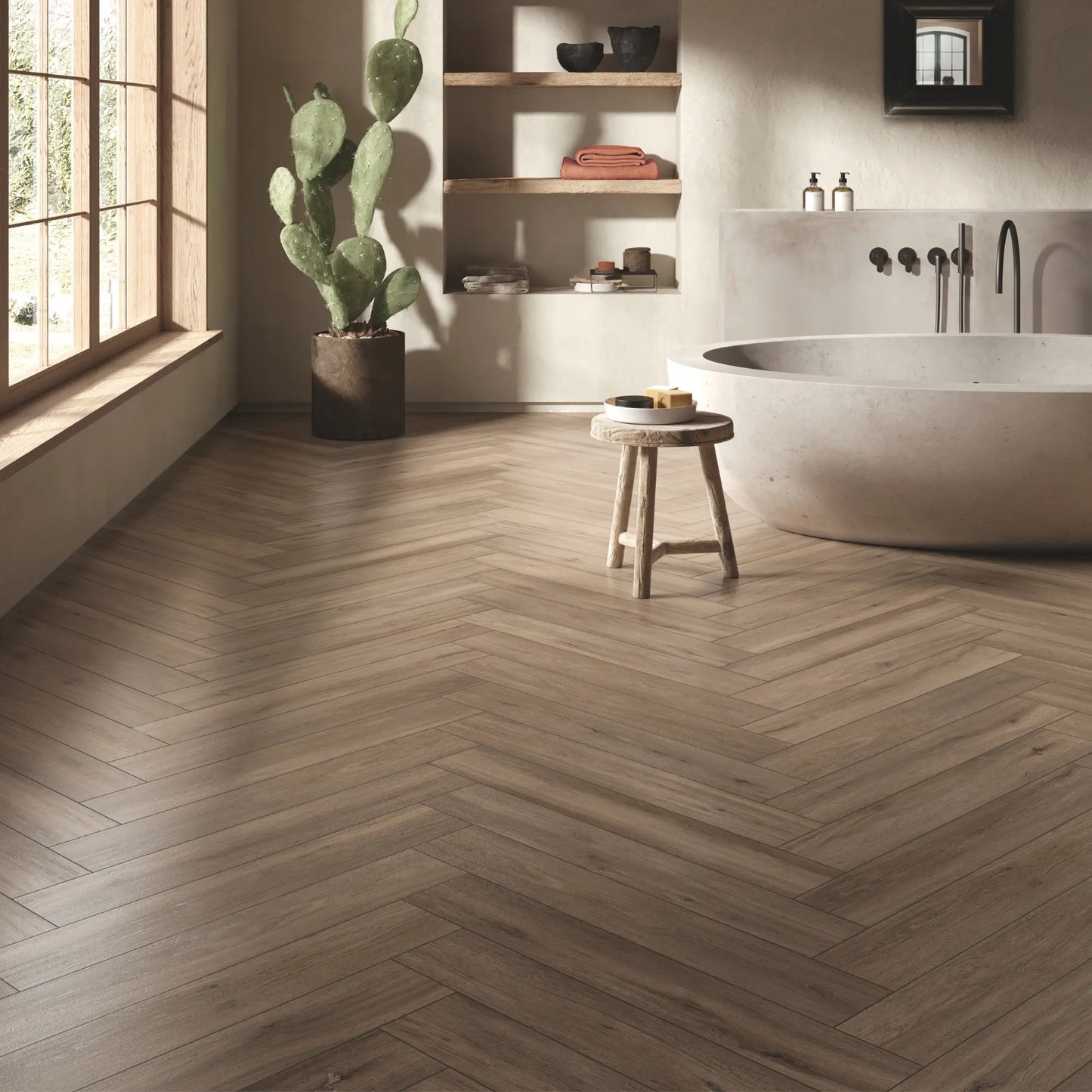 Herringbone taupe oak wood-effect porcelain tile flooring in a warm modern bathroom - Firenze Tortora