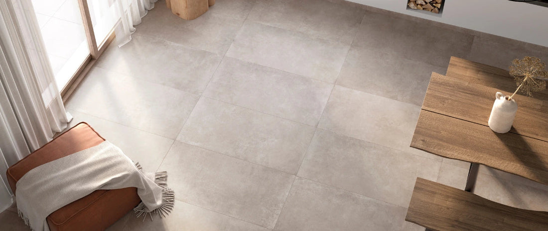 Large-format porcelain floor tiles in a bright, modern living and dining area with natural light.