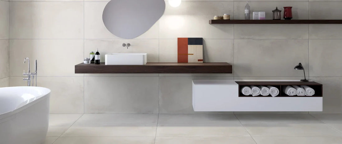 Light concrete effect porcelain tiles in a modern bathroom with large format wall and floor tiles