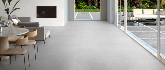 Light grey concrete effect porcelain tiles in an open-plan living room