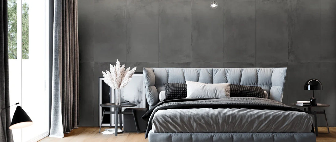 Modern bedroom with wood-effect porcelain tile flooring and 60×120 concrete-effect wall covering. 