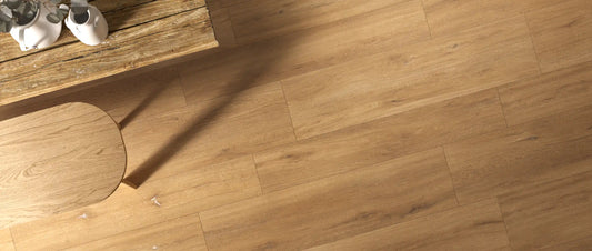 Natural oak wood effect porcelain tiles laid in staggered planks, seen from above in a living room