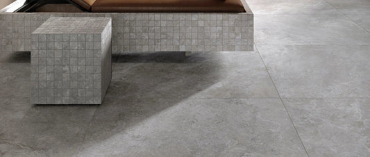 Grey stone-effect porcelain tile flooring in a modern interior, large format tiles with natural texture.