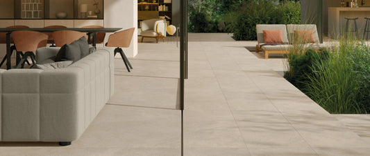 Modern villa with indoor outdoor porcelain tile flooring, seamless transition between living room and garden patio