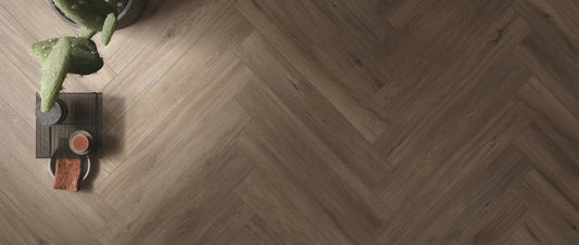 Wood effect porcelain tiles laid in herringbone pattern for a modern hallway