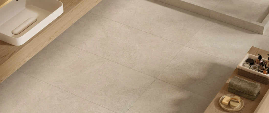 Beige stone-effect porcelain tile flooring in a modern bathroom with natural textures and soft minimal design. Eterea