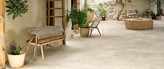 Beige stone effect porcelain tiles in 120x120 format laid in a Mediterranean courtyard