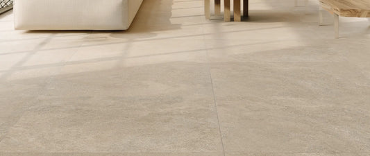 Beige stone-effect porcelain tiles in large format laid in a modern open-plan living room