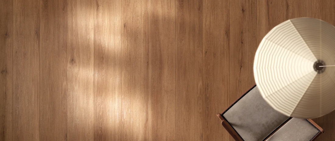 Warm mid-tone oak wood effect porcelain tiles in long planks, lit by sunlight