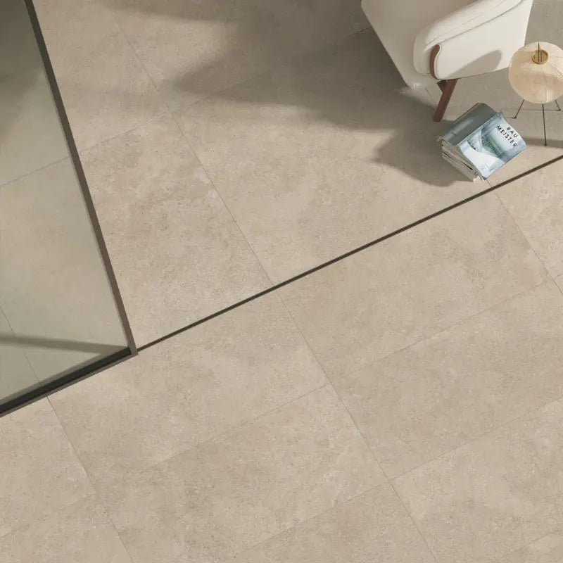 Beige stone-effect porcelain stoneware floor tiles in a modern indoor and outdoor living space.