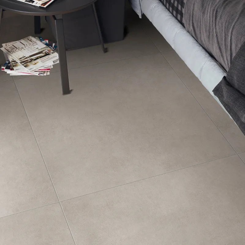 Concrete-effect porcelain stoneware floor tiles in a modern bedroom interior.