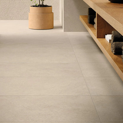 Bathroom interior featuring beige stone-effect porcelain floor tiles, eterea sabbia