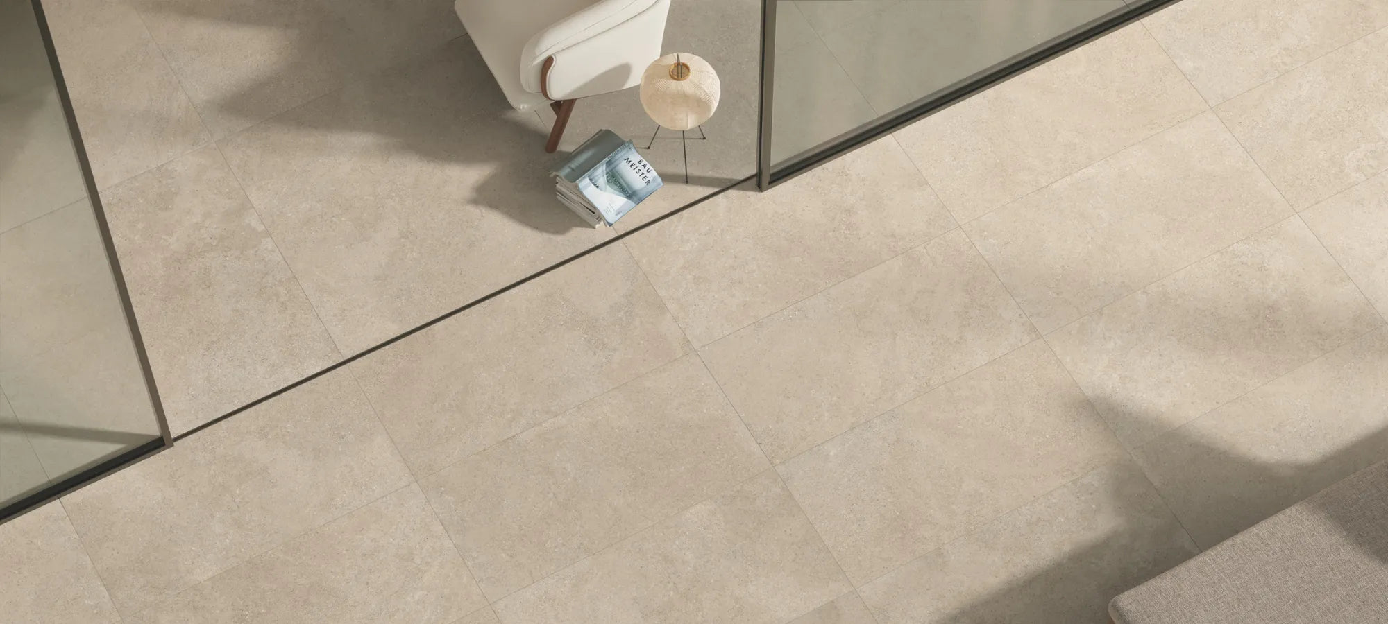 Beige stone-effect porcelain stoneware floor tiles in a modern indoor and outdoor living space.