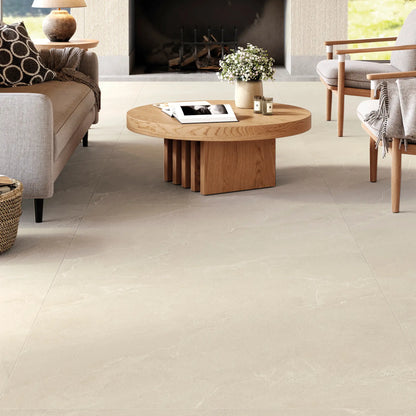 Living room with beige stone effect porcelain tile flooring, Cortina Stone Sabbia