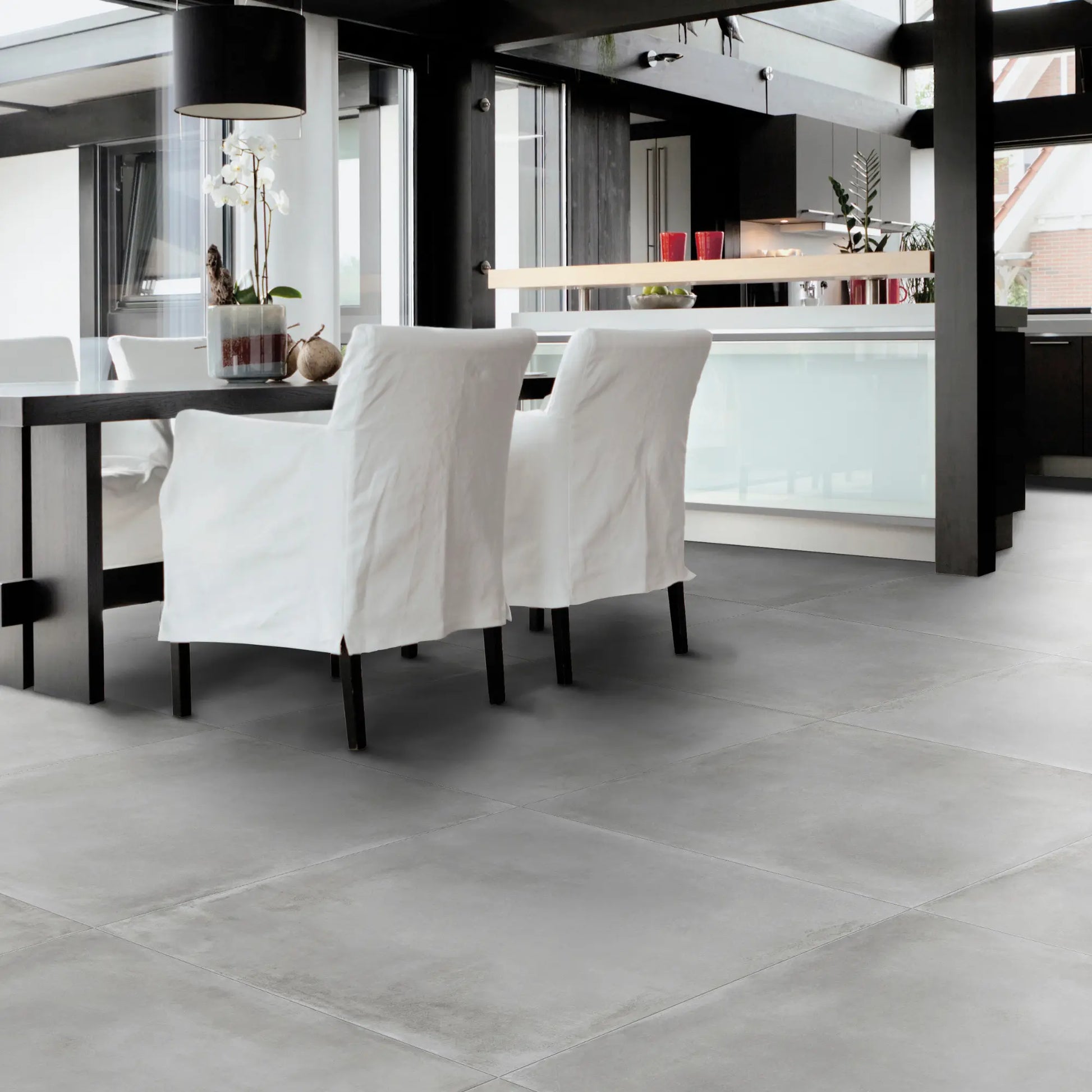 Grey concrete effect porcelain floor in contemporary dining room Caementum Griseo