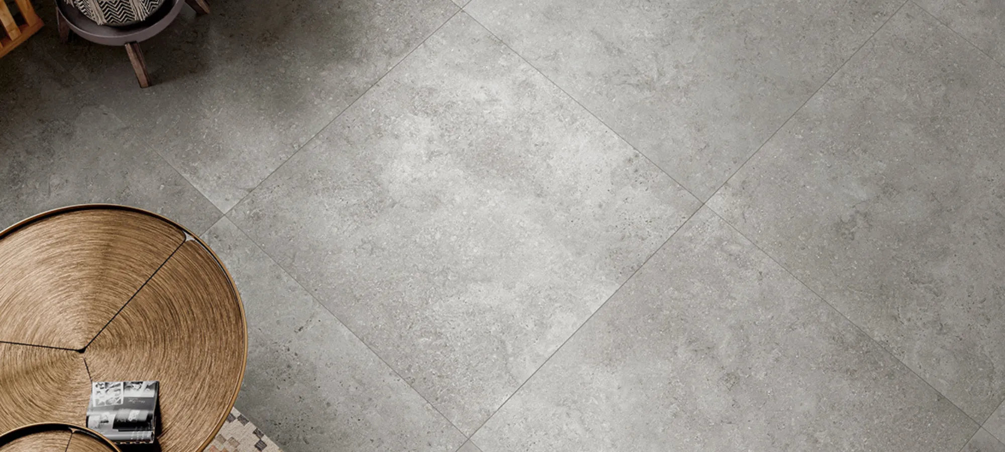 Grey stone-effect 90x90 porcelain stoneware floor tile in a modern interior.