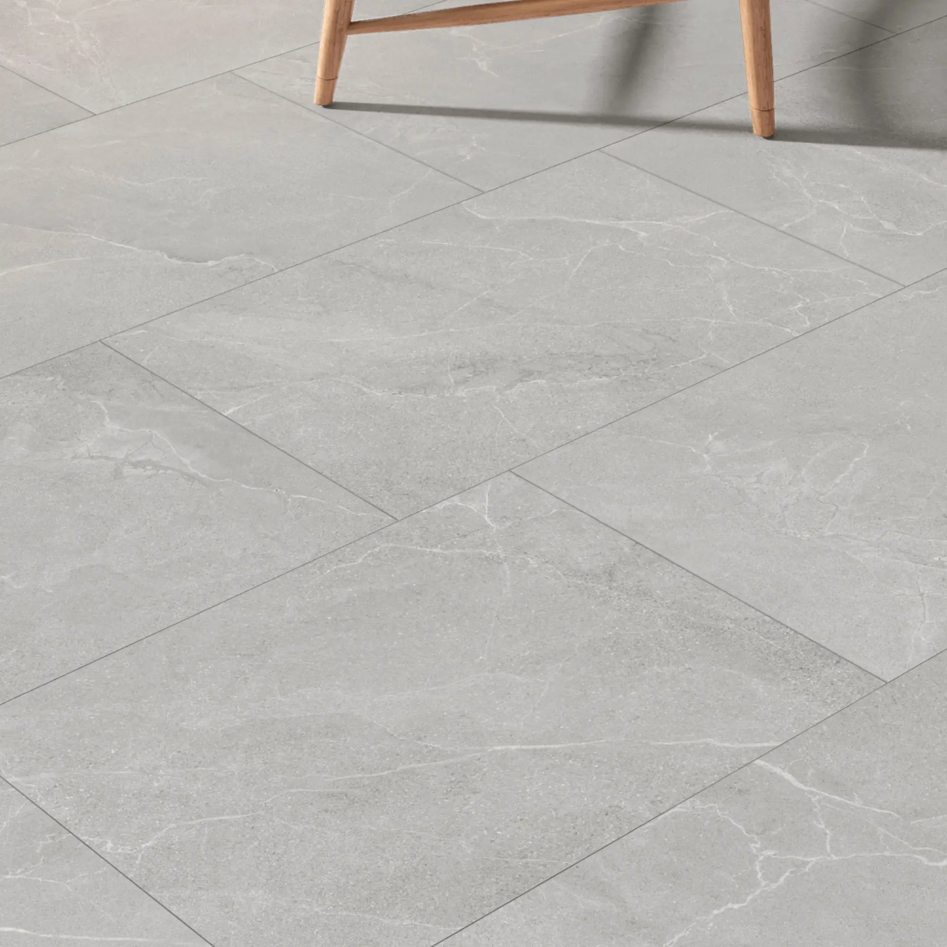 Grey stone effect porcelain tiles installed in a modern room, Cortina Stone Cenere