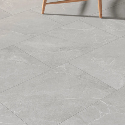 Grey stone effect porcelain tiles installed in a modern room, Cortina Stone Cenere