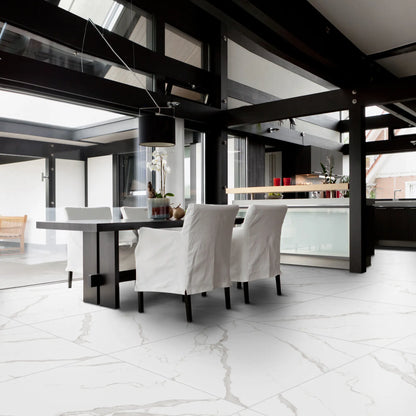 Modern dining room with matte marble-effect porcelain tile flooring, featuring soft grey veining, white marble statuario