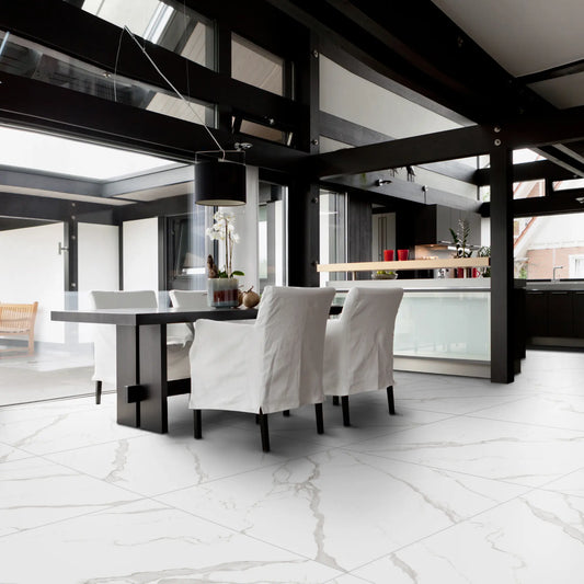 Modern dining room with matte marble-effect porcelain tile flooring, featuring soft grey veining, white marble statuario