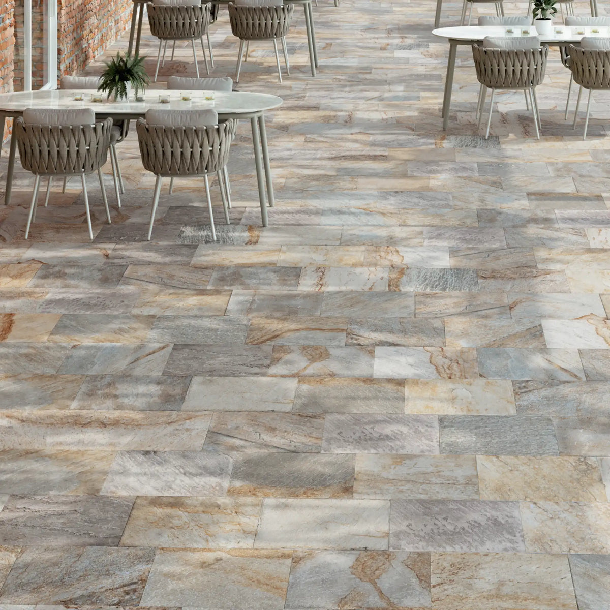 Large outdoor terrace paved with grey-beige stone-effect porcelain tiles with R11 anti-slip finish, designed for high-traffic exterior spaces, Pietra di Serra
