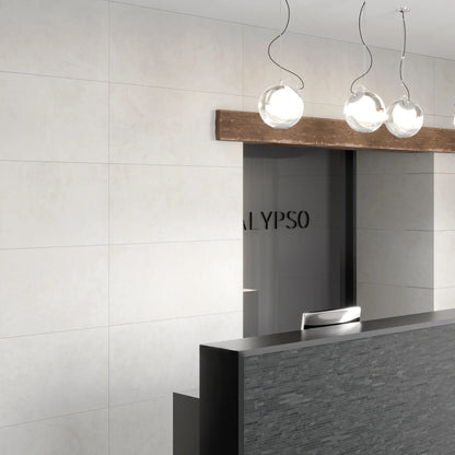 White concrete-effect porcelain wall and floor tiles in a modern commercial space, Le Resine Bianco
