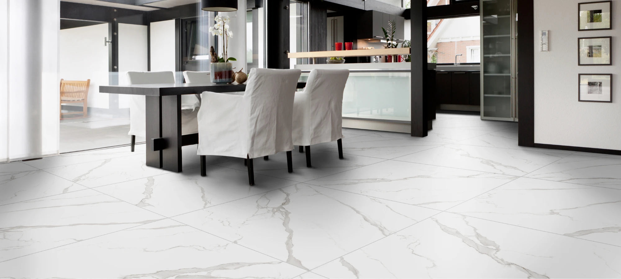 Modern dining room with white marble-effect porcelain stoneware tiles featuring elegant grey veining.