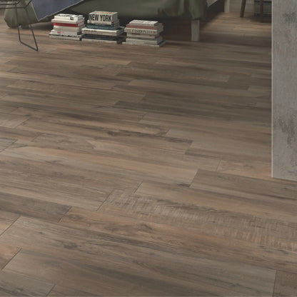 Close-up of brown oak wood-effect porcelain flooring with rich tonal variation in a modern bedroom – North Wind Melange
