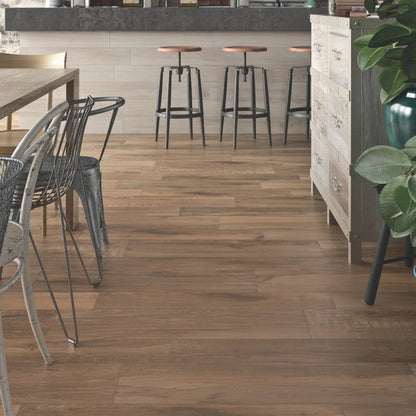 Brown oak wood-effect porcelain flooring in a modern kitchen and bar area – North Wind Brown