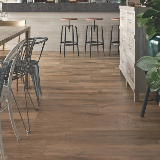 Brown oak wood-effect porcelain flooring in a modern kitchen and bar area – North Wind Brown