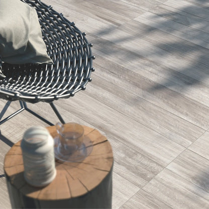 Close-up of grey oak wood-effect porcelain tiles used in an outdoor seating area – North Wind Grey