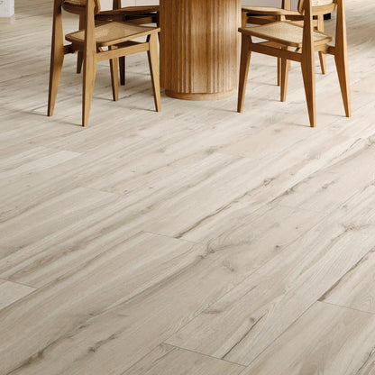 Light wood-effect porcelain flooring in a modern dining room, close up – Natura Magnolia
