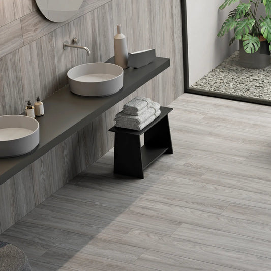 Light grey wood-effect porcelain tile flooring in a contemporary bathroom - Skyline Grey
