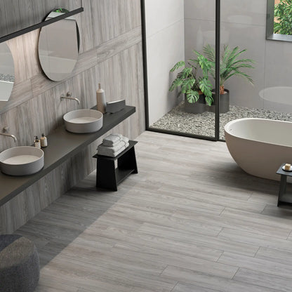 Modern bathroom with light grey wood-effect porcelain tile flooring and soft natural lighting - Skyline Grey