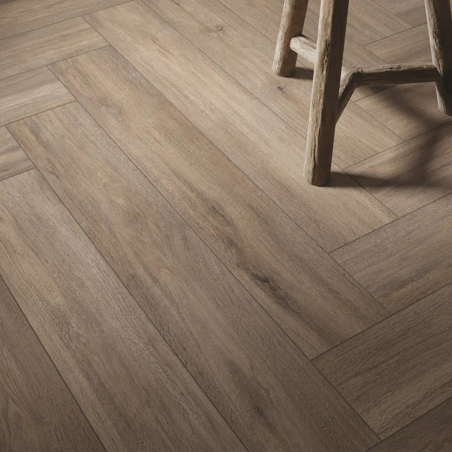 Detail of taupe oak wood-effect porcelain tiles laid in herringbone pattern - Firenze Tortora
