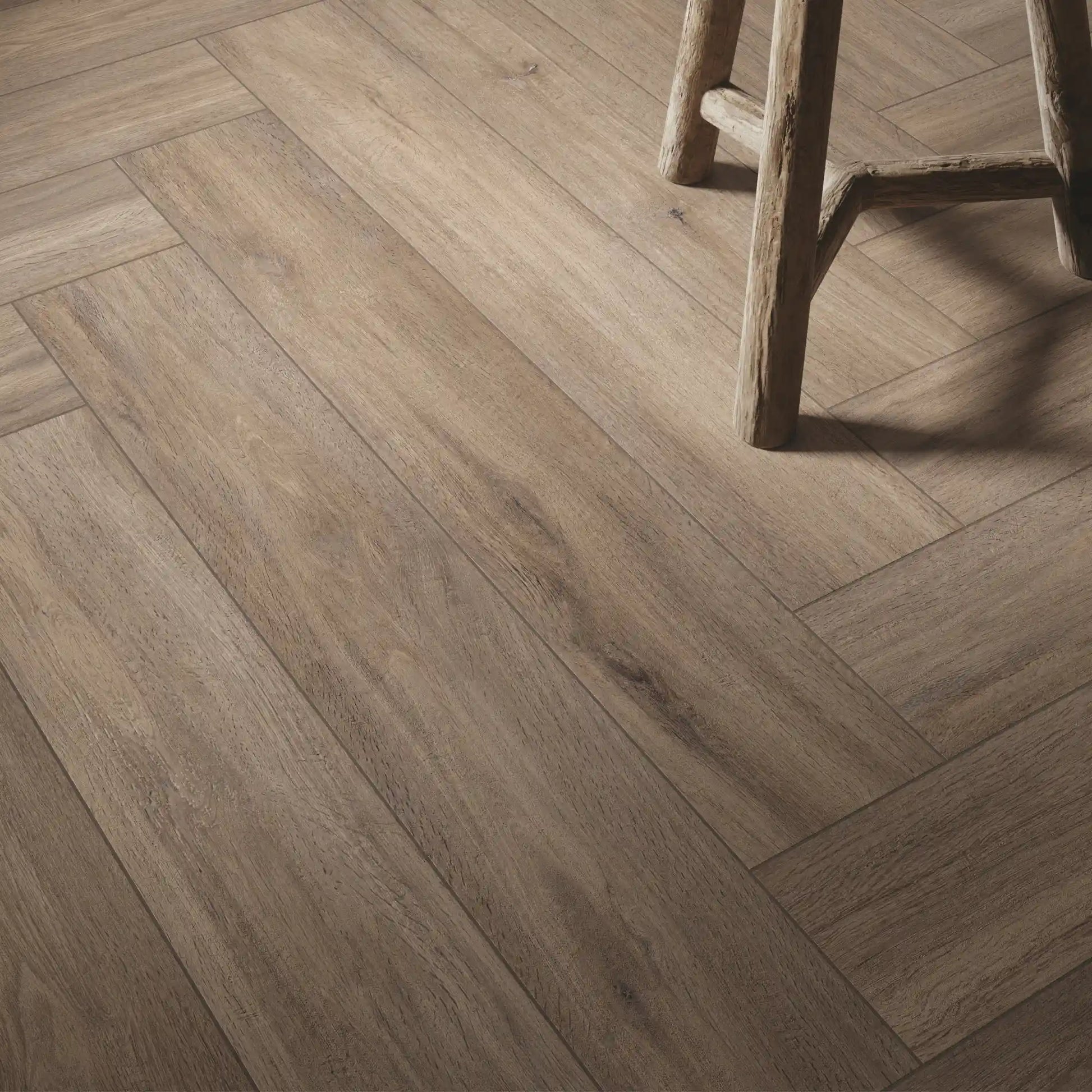 Detail of taupe oak wood-effect porcelain tiles laid in herringbone pattern - Firenze Tortora