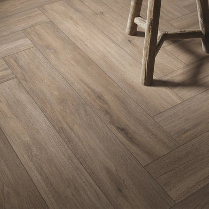Detail of taupe oak wood-effect porcelain tiles laid in herringbone pattern - Firenze Tortora