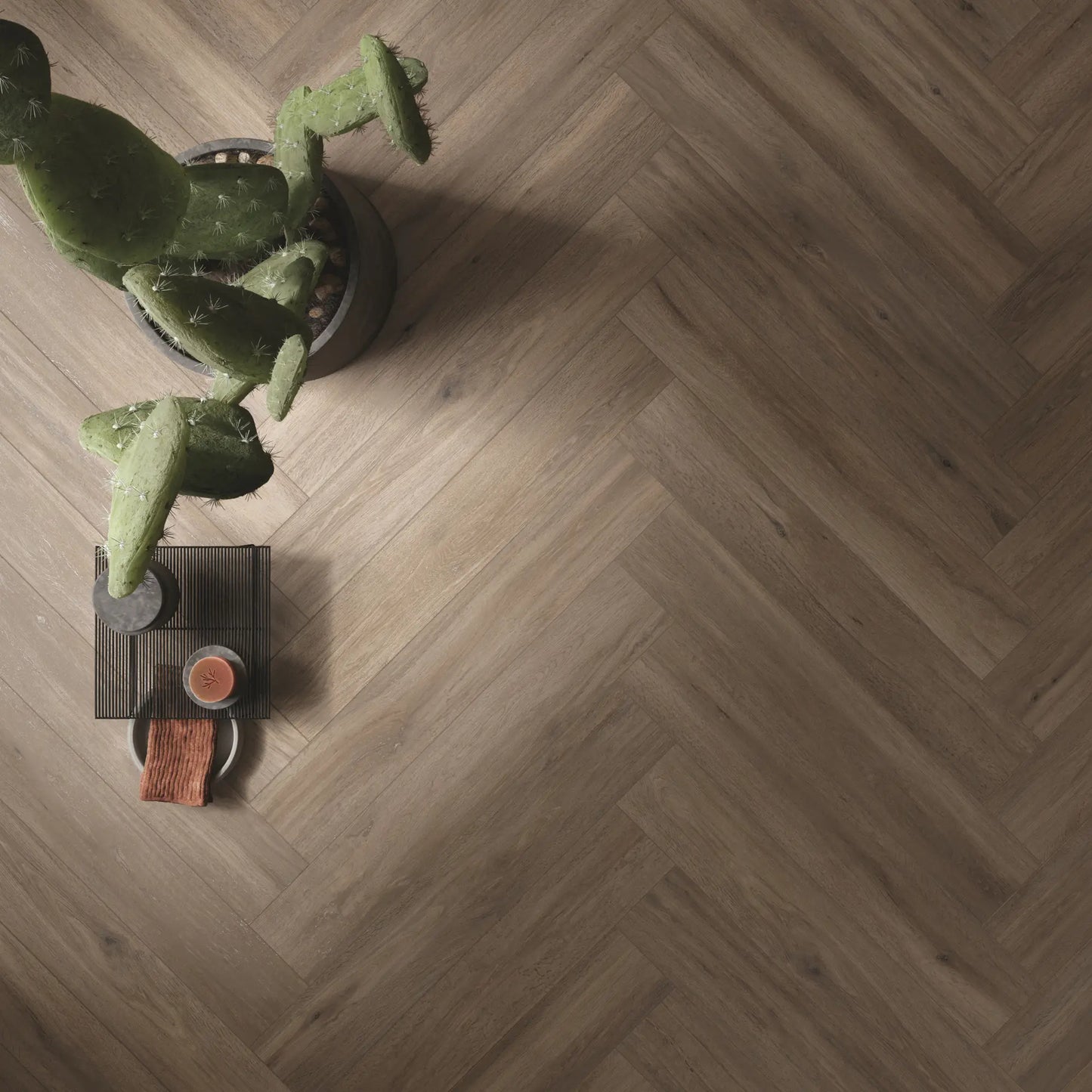Top view of taupe oak wood-effect porcelain tiles laid in herringbone pattern - Firenze Tortora