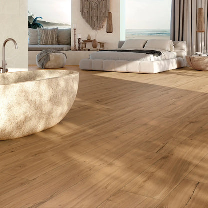 Warm oak wood-effect porcelain tile flooring in a modern bedroom and bath space – Natura Ciliegio